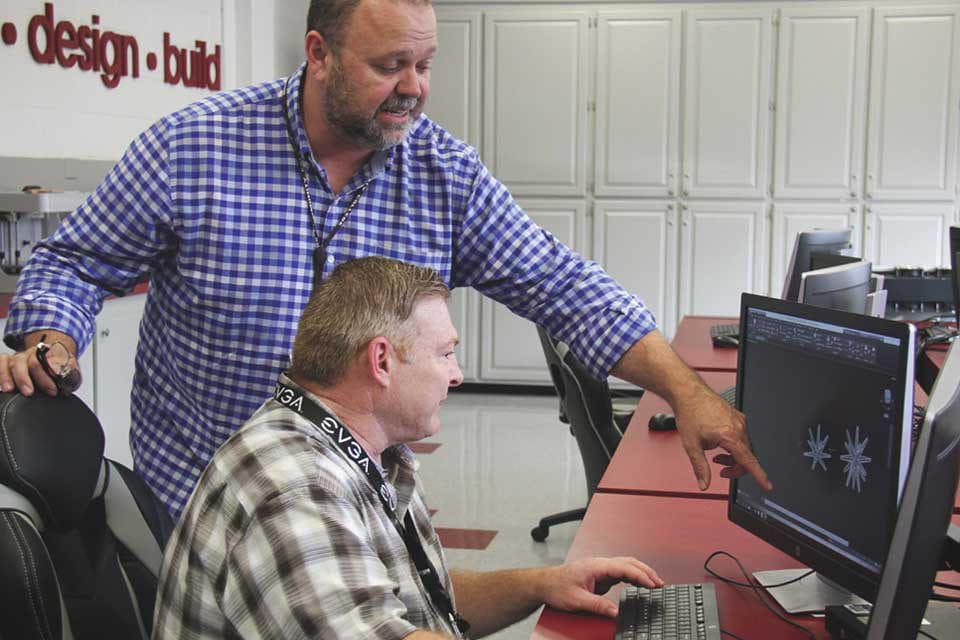 instructor with student at computer